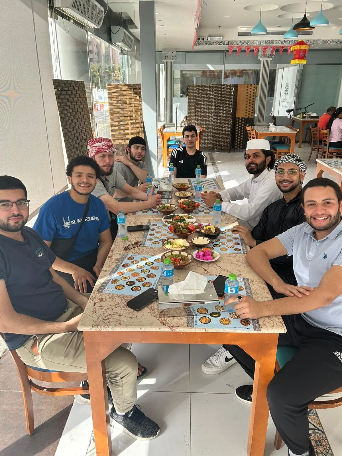 Students gathered around a shared breakfast table in Jeddah.